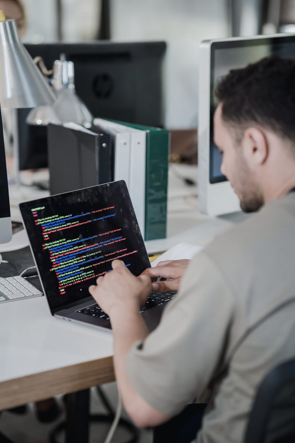 Developer working at a laptop, writing code