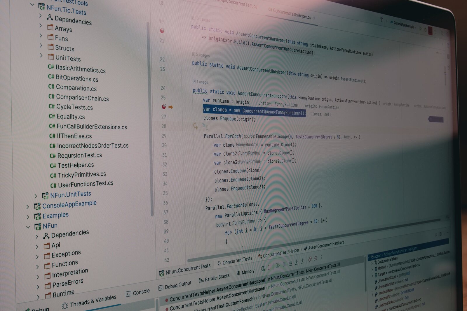 Developer debugging real application code across a multi-monitor setup